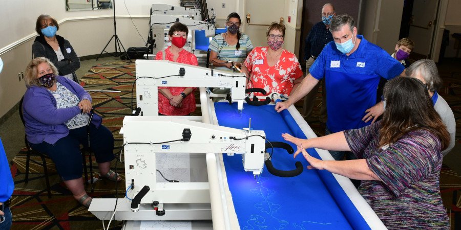 Group of people trying APQS Lucey and Lenni machines