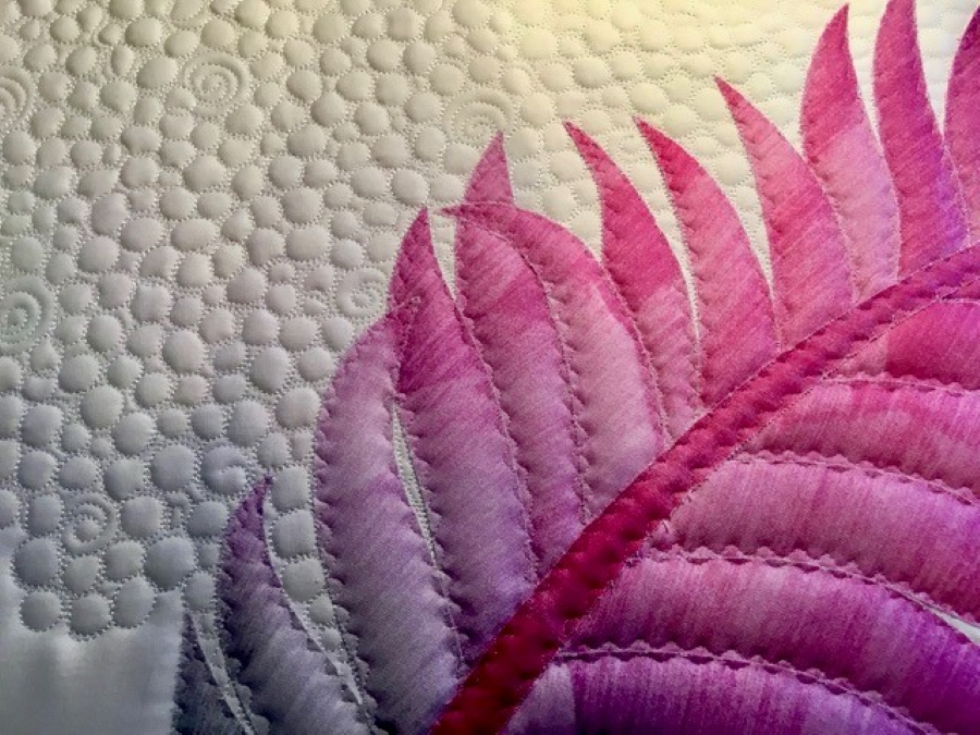 Stitch in the ditch alternative on fused applique quilt with pearl background fill